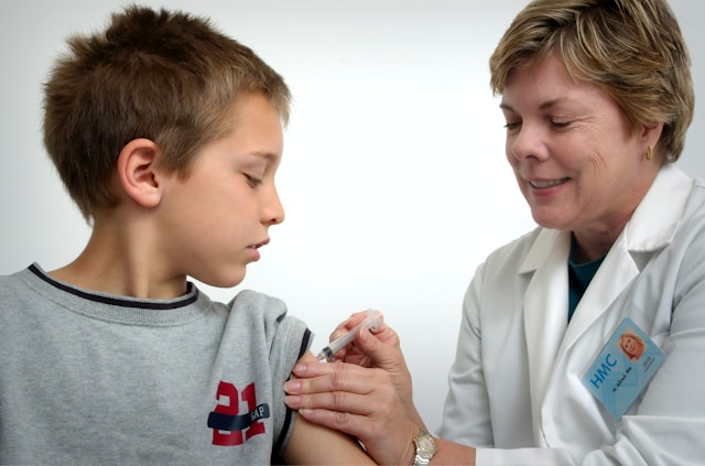 A doctor vaccinating a child