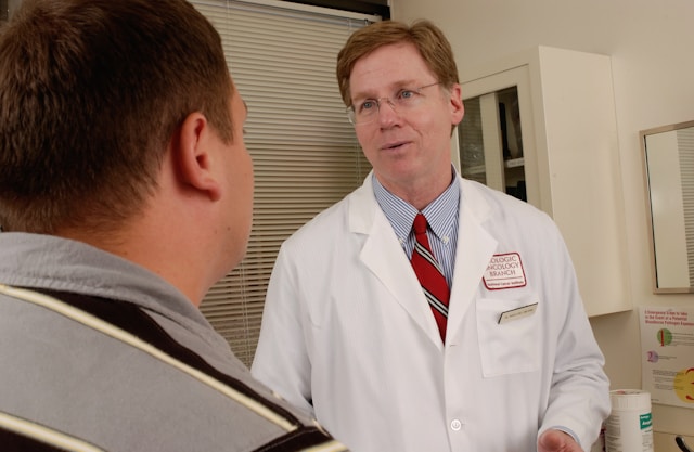 A senior doctor talking to a patient