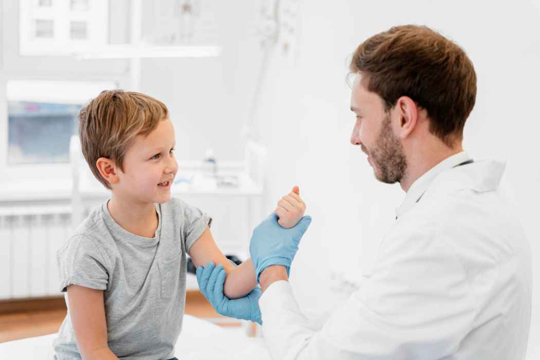 Doctor examining a child’s arm during a pediatric orthopedic consultation