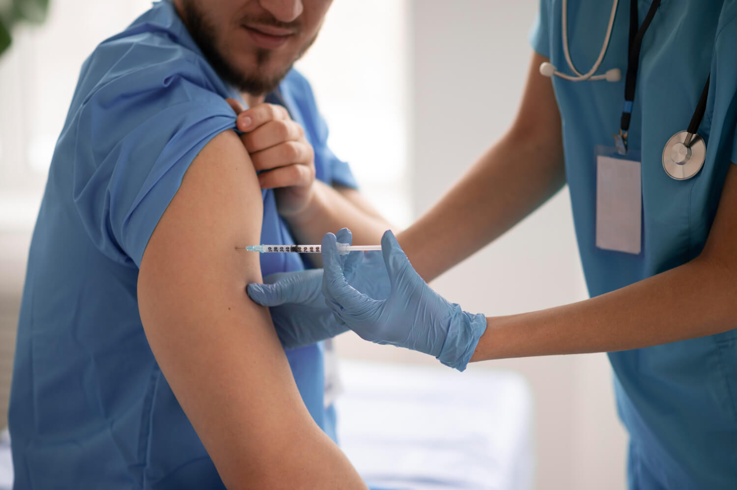 Healthcare professional administering an injection to a patient’s upper arm