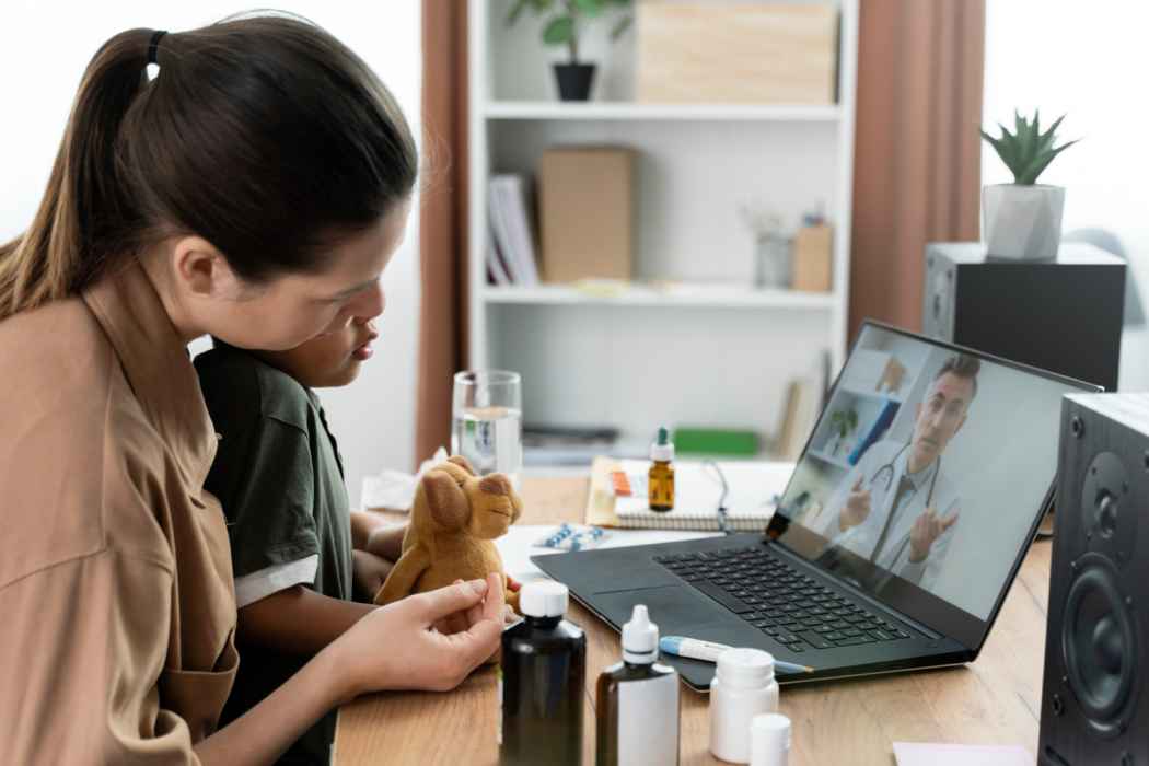 Parent holding a child during an online doctor consultation at home