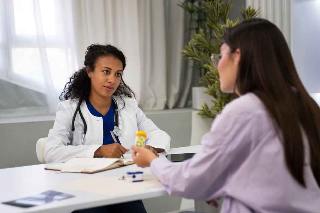 Doctor consulting with a patient and reviewing medication in a clinic