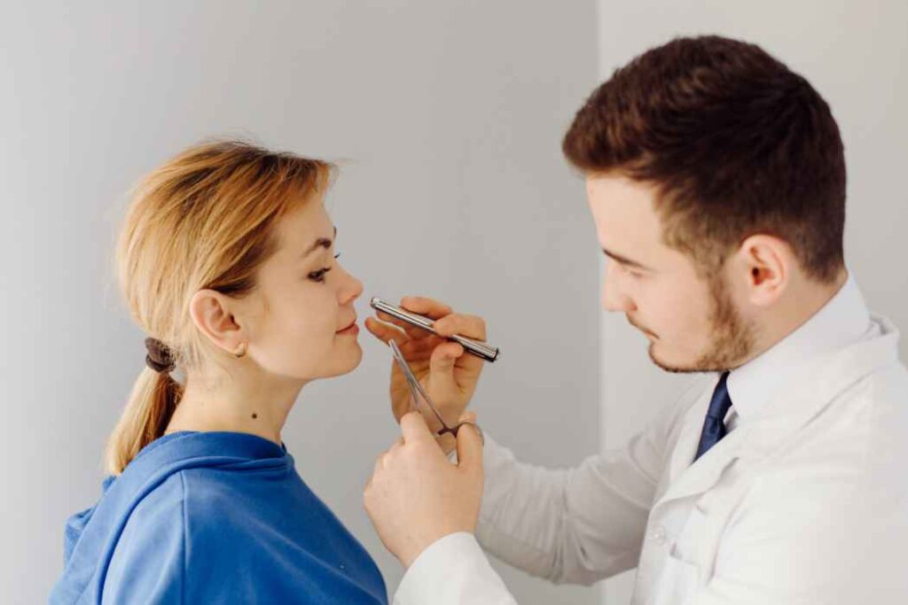 ENT specialist evaluating a patient for sinus and nasal symptoms