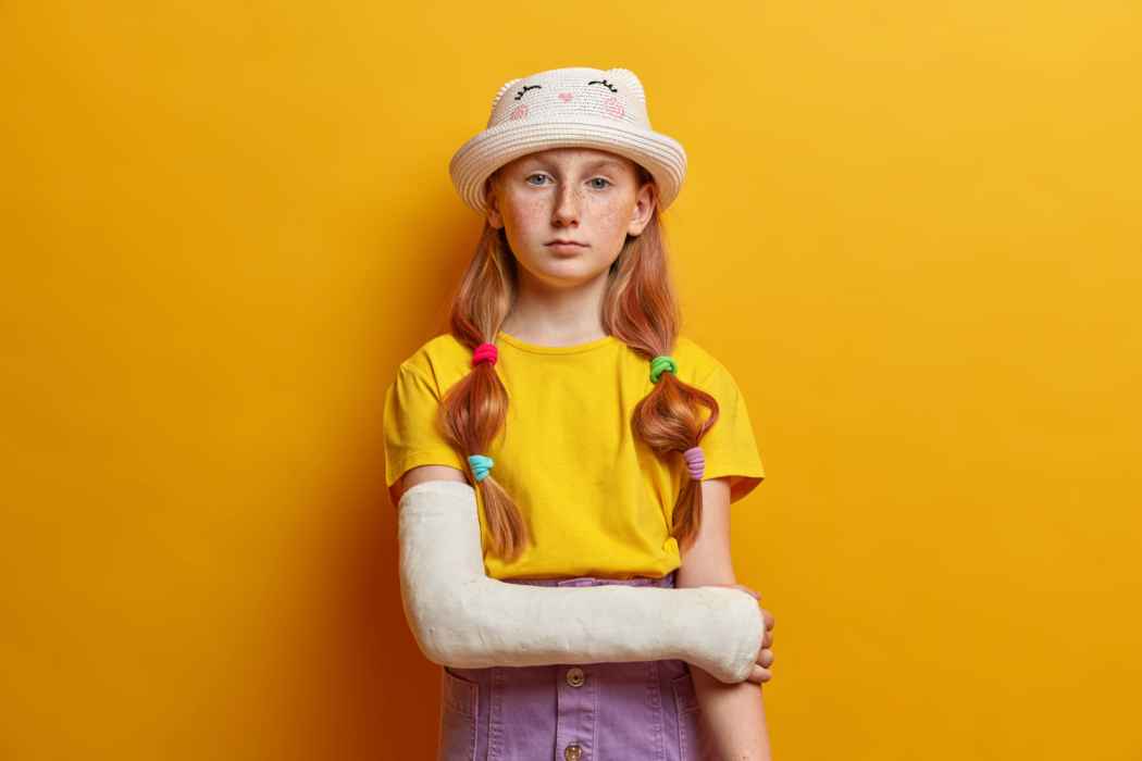 Young child wearing an arm cast after fracture treatment.