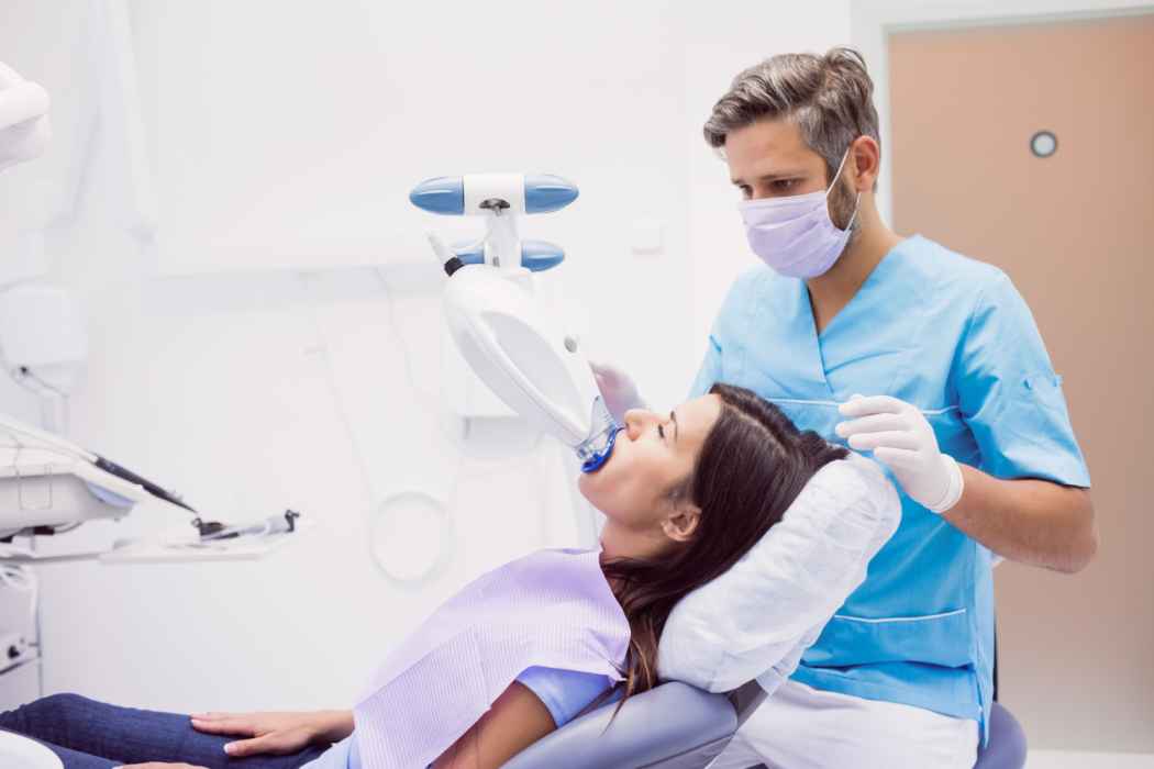 Dentist performing a dental examination using advanced diagnostic equipment