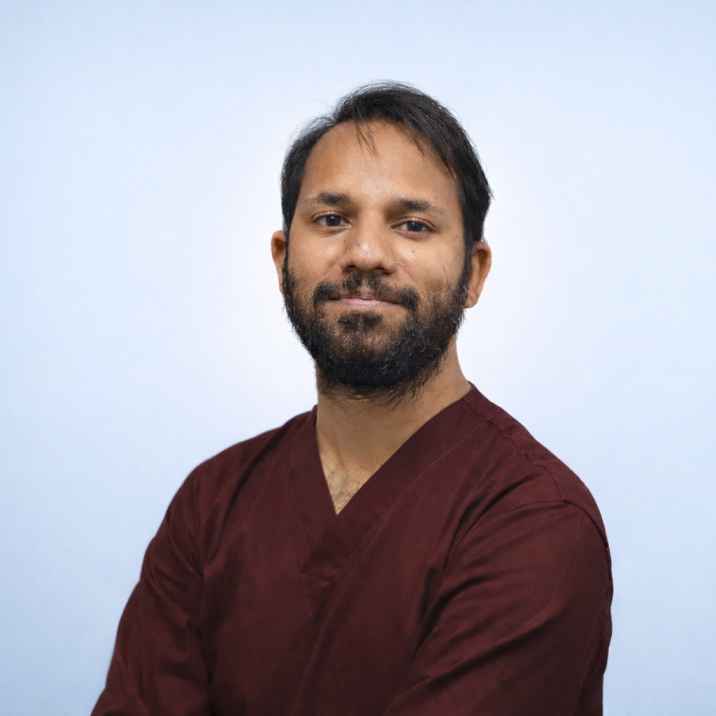 An Indian male in Maroon dress