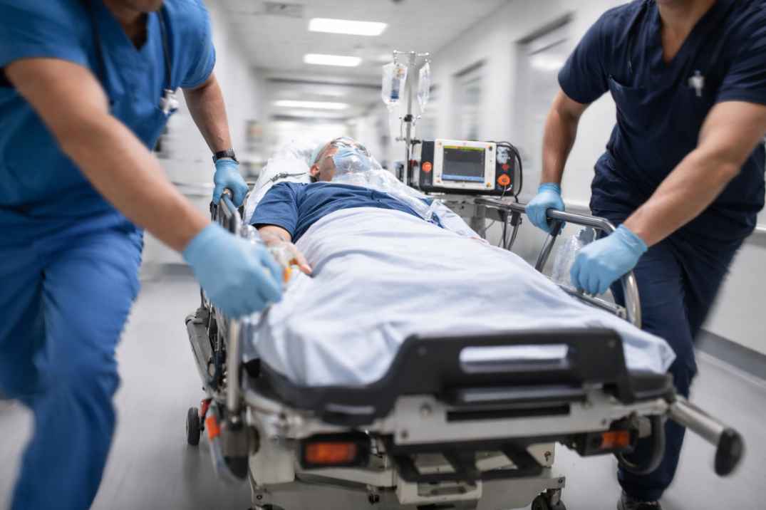 Emergency medical team transporting a patient on a hospital stretcher during urgent care response