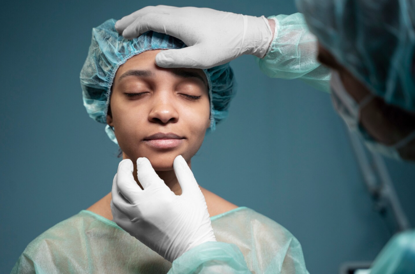 Medical professional assessing facial features before a clinical procedure