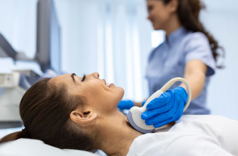 Healthcare professional performing an ultrasound scan on a patient’s neck