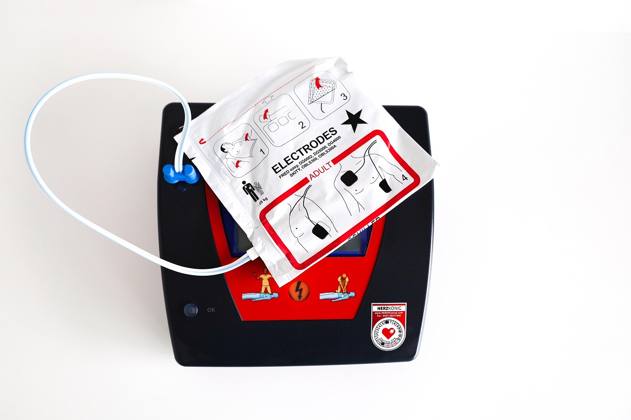 Automated external defibrillator with adult electrode pads used for emergency cardiac response.