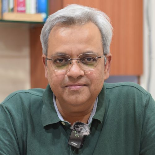 An Indian middle aged male in green t-shirt