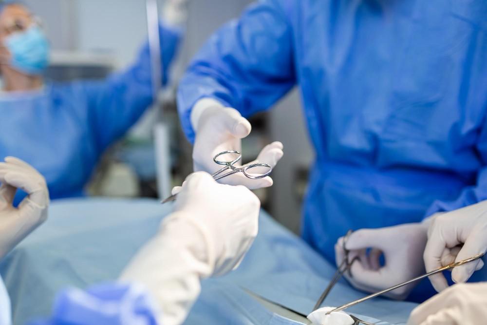 Surgeons holding instruments