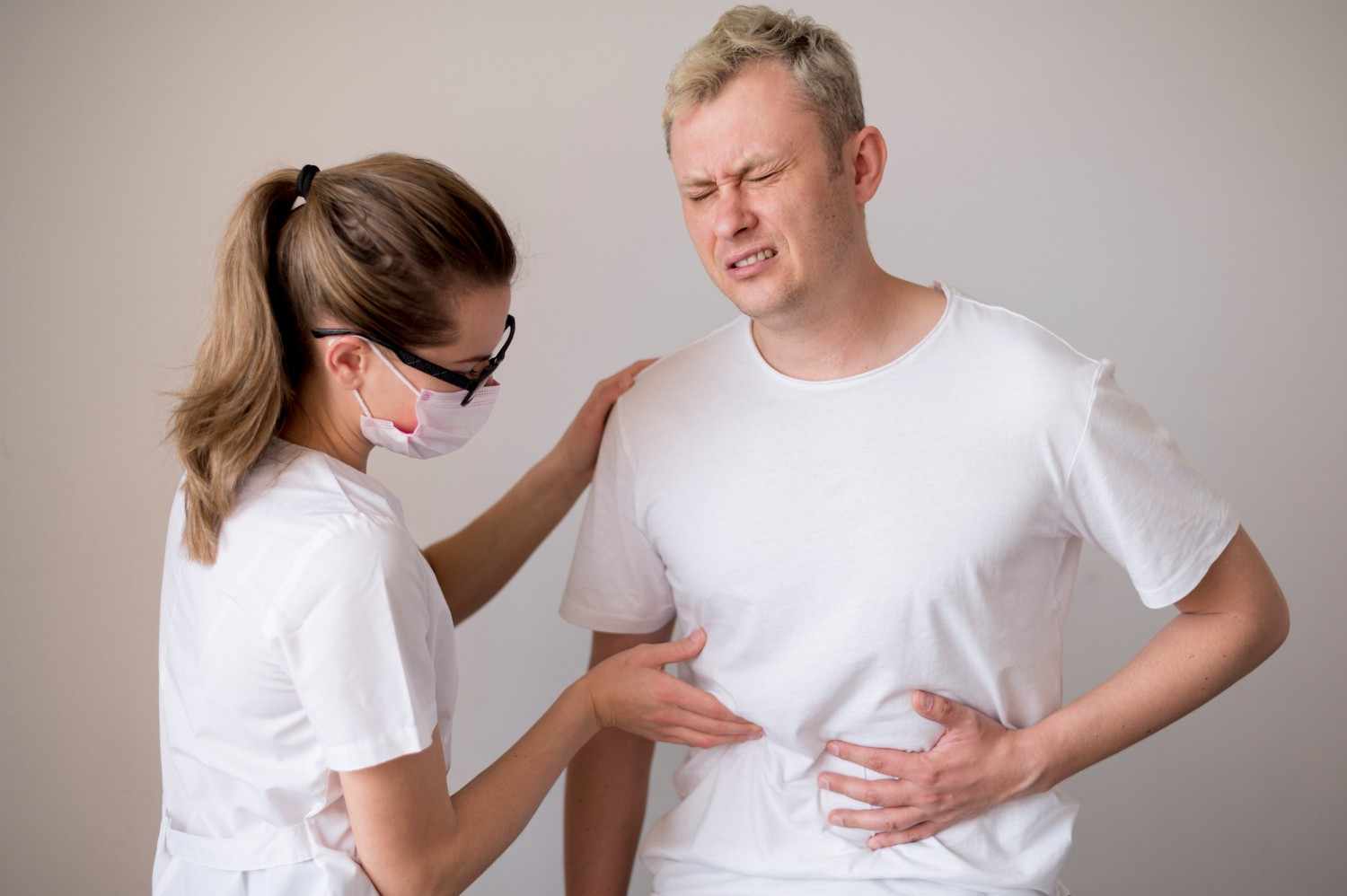 A doctor inspecting stomach of a patient