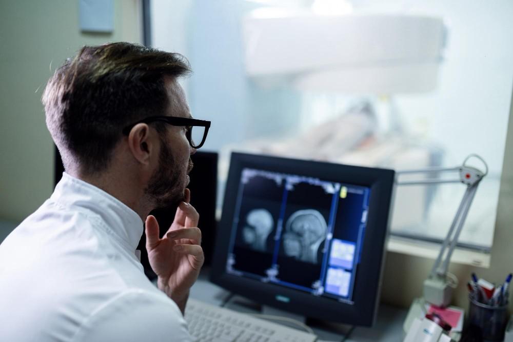 A doctor looking at Neuro Images on Computer