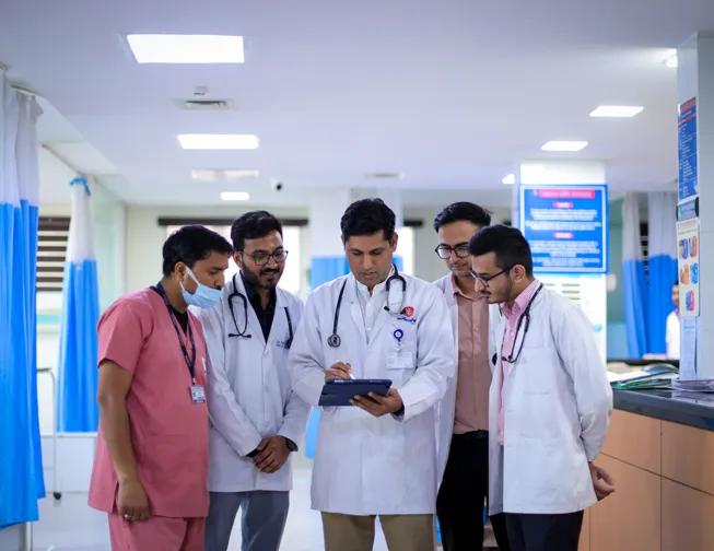 Multidisciplinary clinic specialists discussing patient care and treatment planning