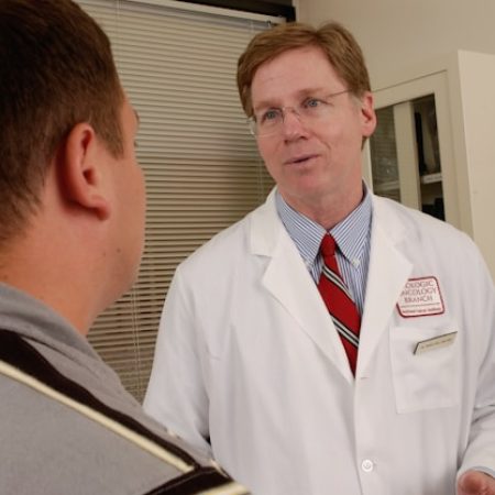 A senior doctor talking to a patient